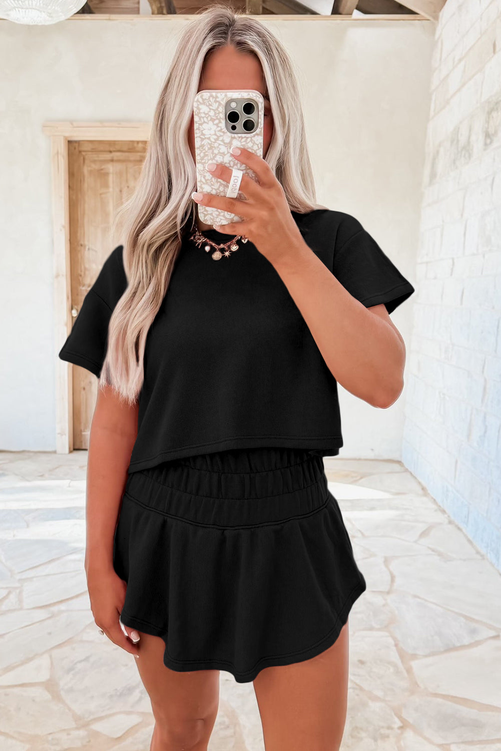 Black 2pcs Cropped Tee and Ruffle High Waist Skort Set.